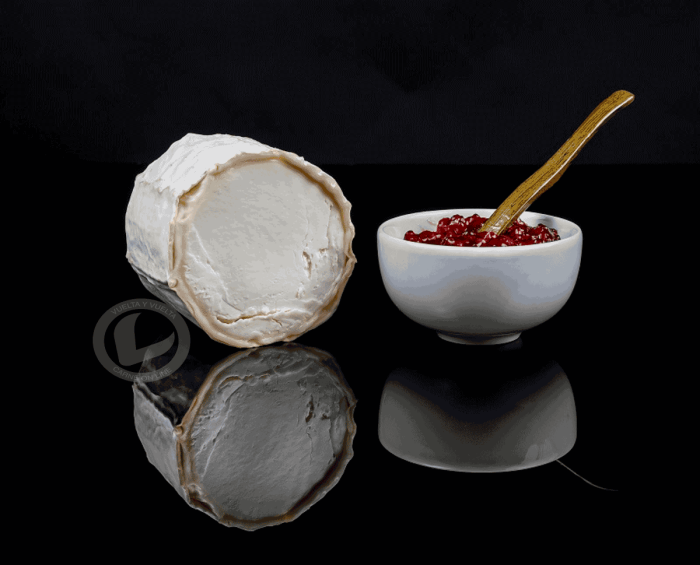 Corte de Rulo de cabra Vuelta y Vuelta y un pequeño bowl de mermelada de fresa